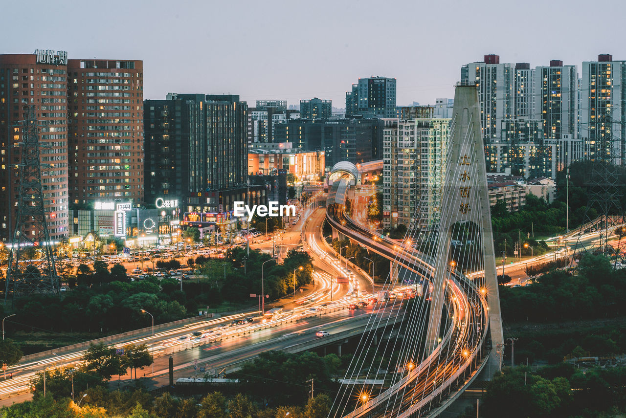 High angle view of illuminated road in city against sky