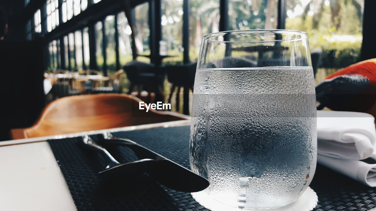 Condensed glass on table in cafe