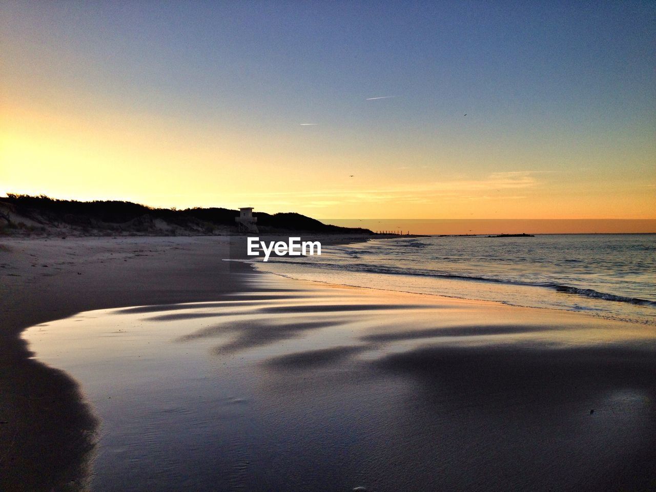 View of beach at sunset