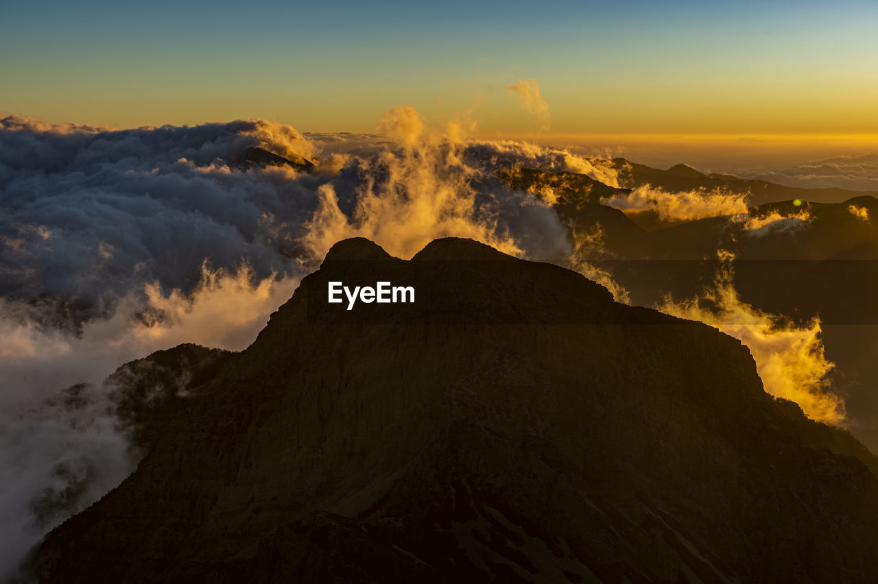 View of volcanic mountain during sunset