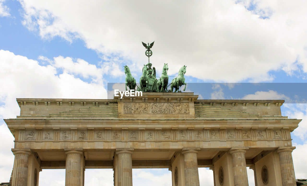 Low angle view of statue against cloudy sky.   berlin