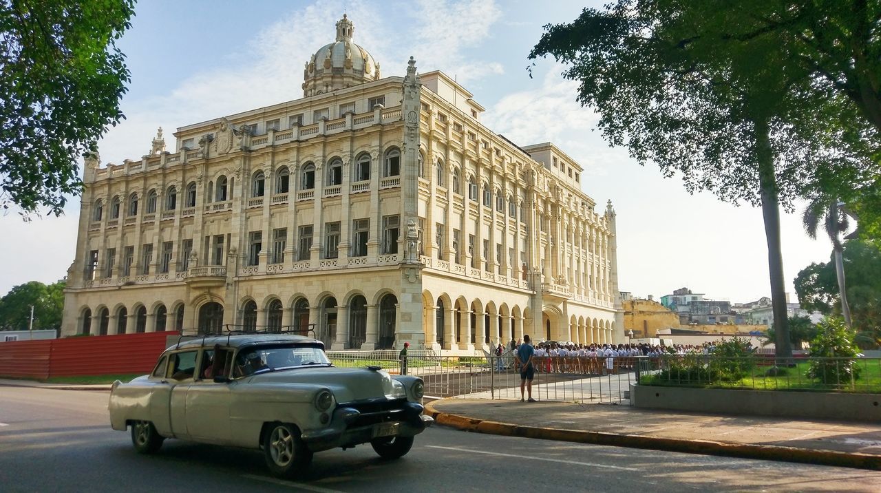 CARS PARKED IN FRONT OF BUILDING