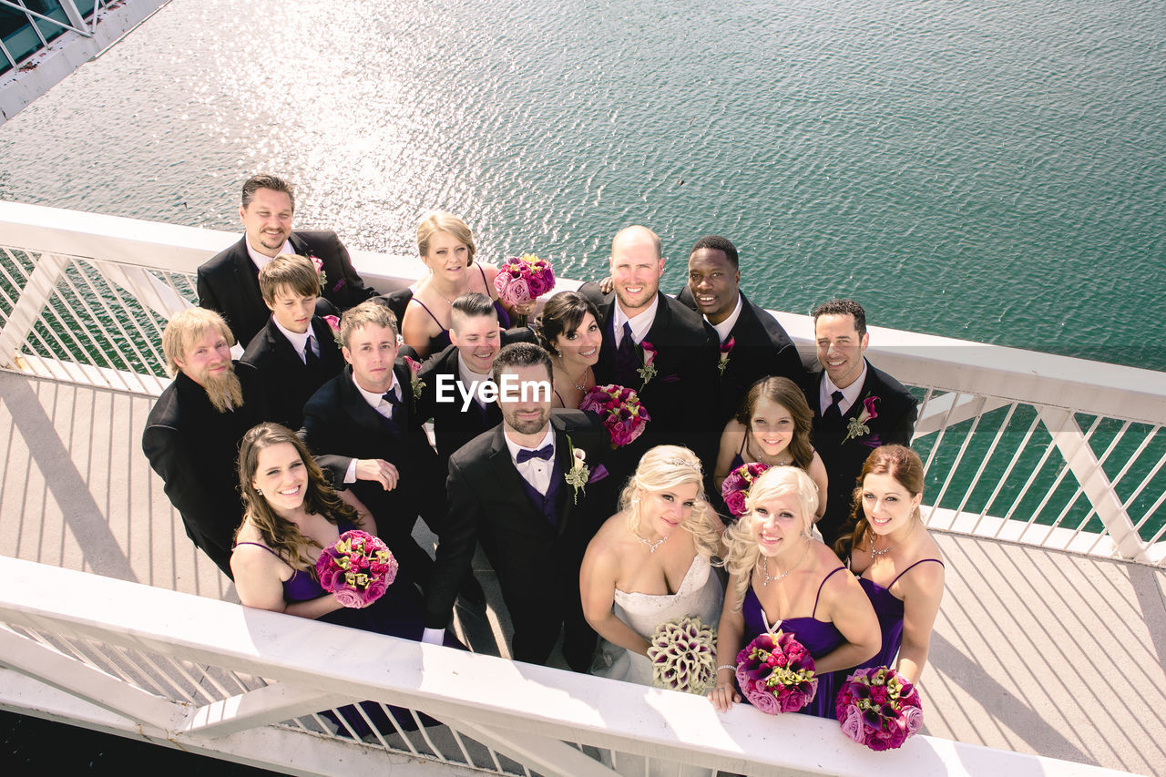 HIGH ANGLE VIEW OF PEOPLE SITTING ON STAIRCASE