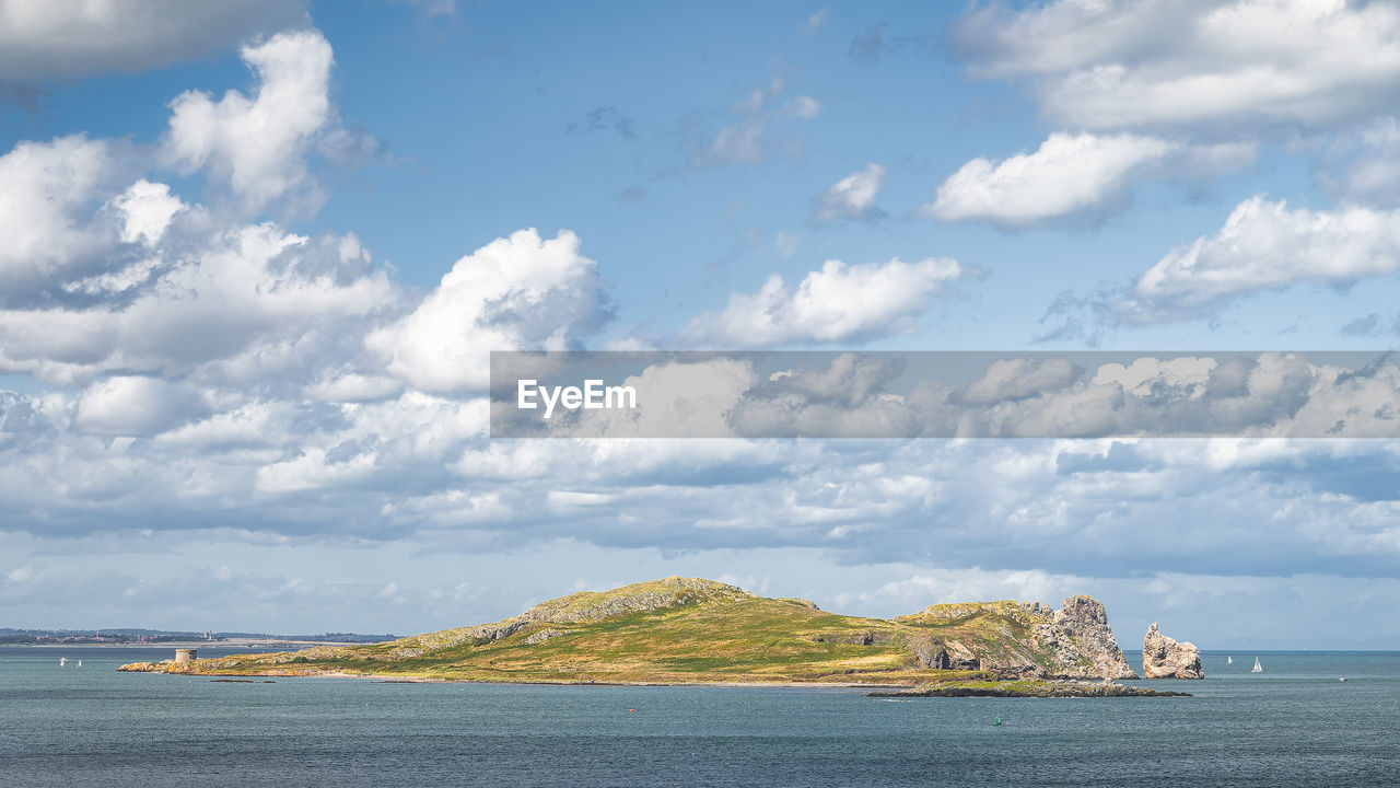 Small rocky island called irelands eye with martello tower