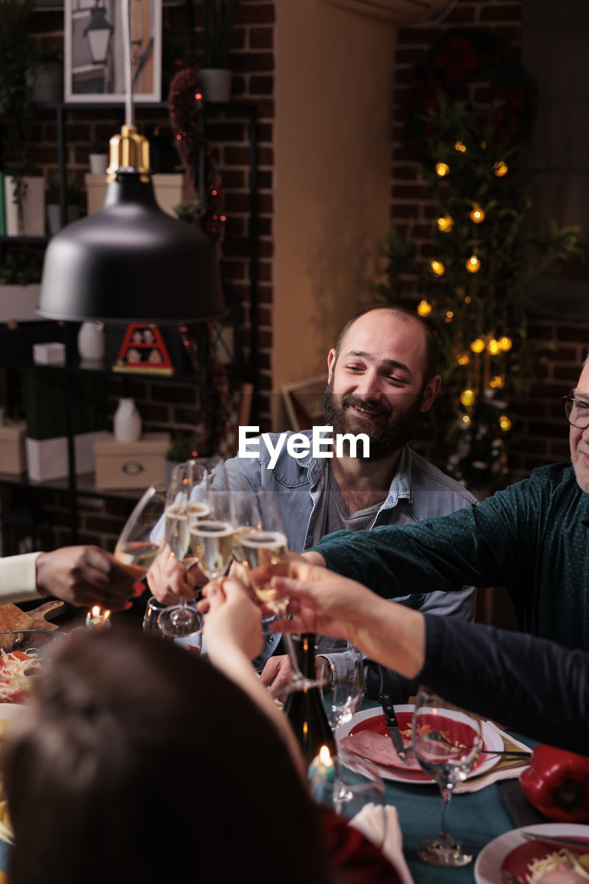 portrait of smiling friends sitting in restaurant