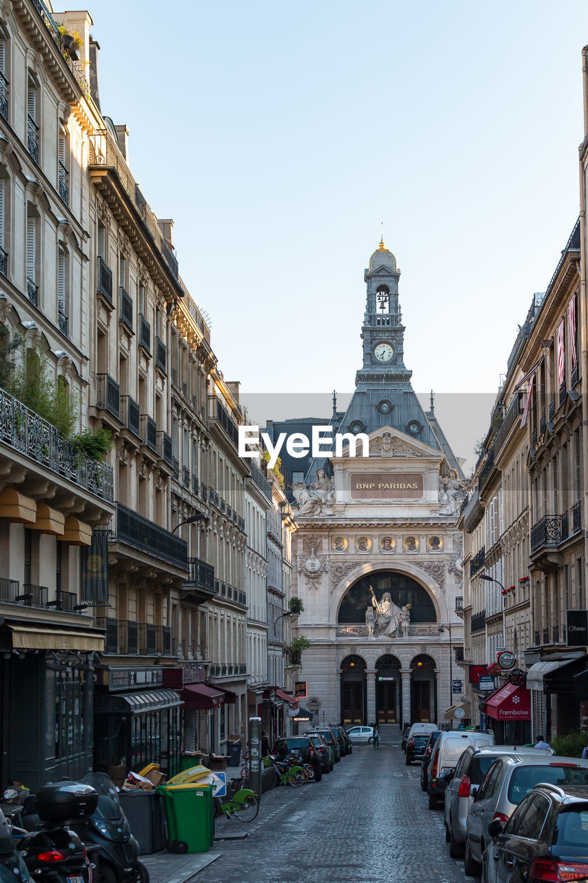 Paris street amidst buildings in city against sky