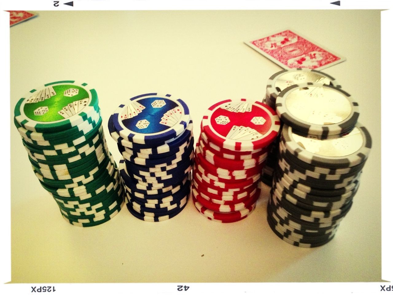 CLOSE-UP OF MULTI COLORED OBJECTS ON TABLE