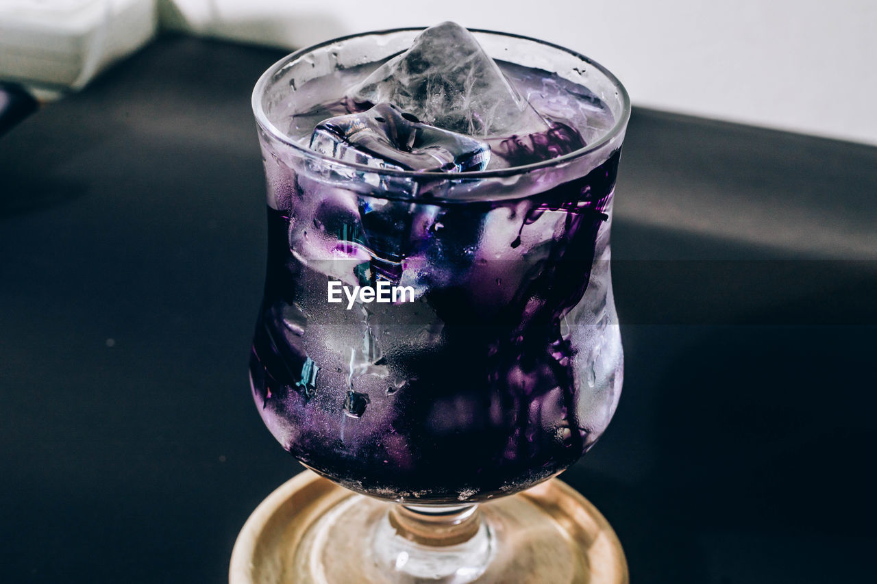 purple, drink, glass, drinking glass, food and drink, indoors, household equipment, refreshment, no people, table, close-up, alcoholic beverage, freshness, vase, cobalt blue, cold temperature, still life, nature