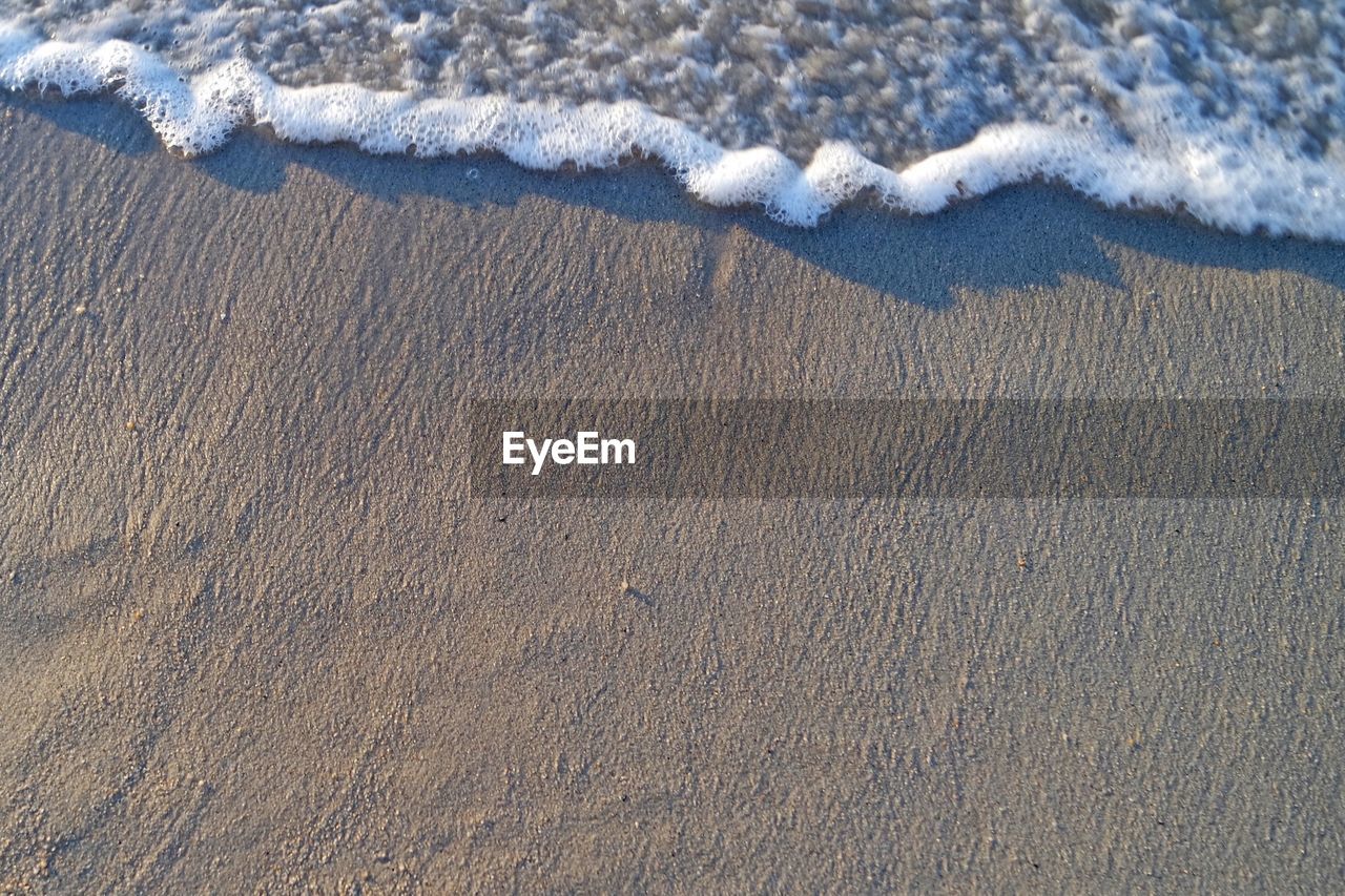 Aerial view of sand at beach during winter