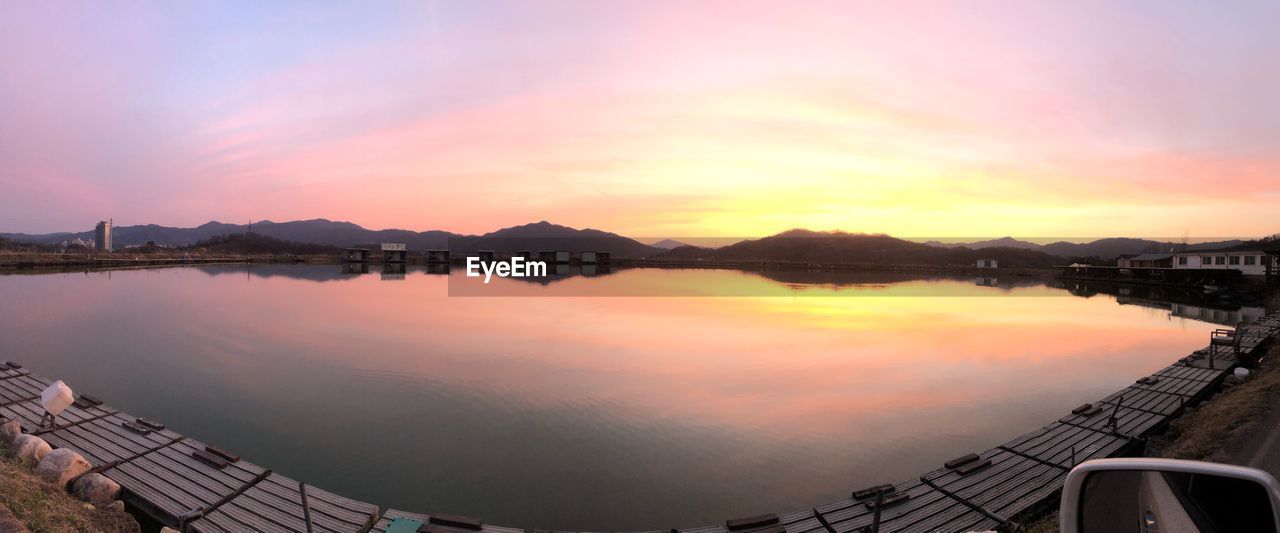 SCENIC VIEW OF LAKE AGAINST ORANGE SKY