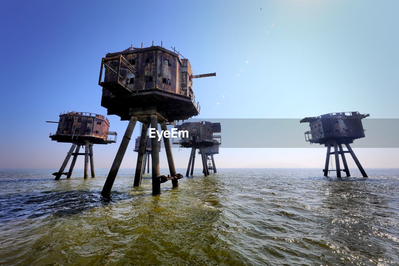 LIFEGUARD HUT BY SEA AGAINST CLEAR SKY