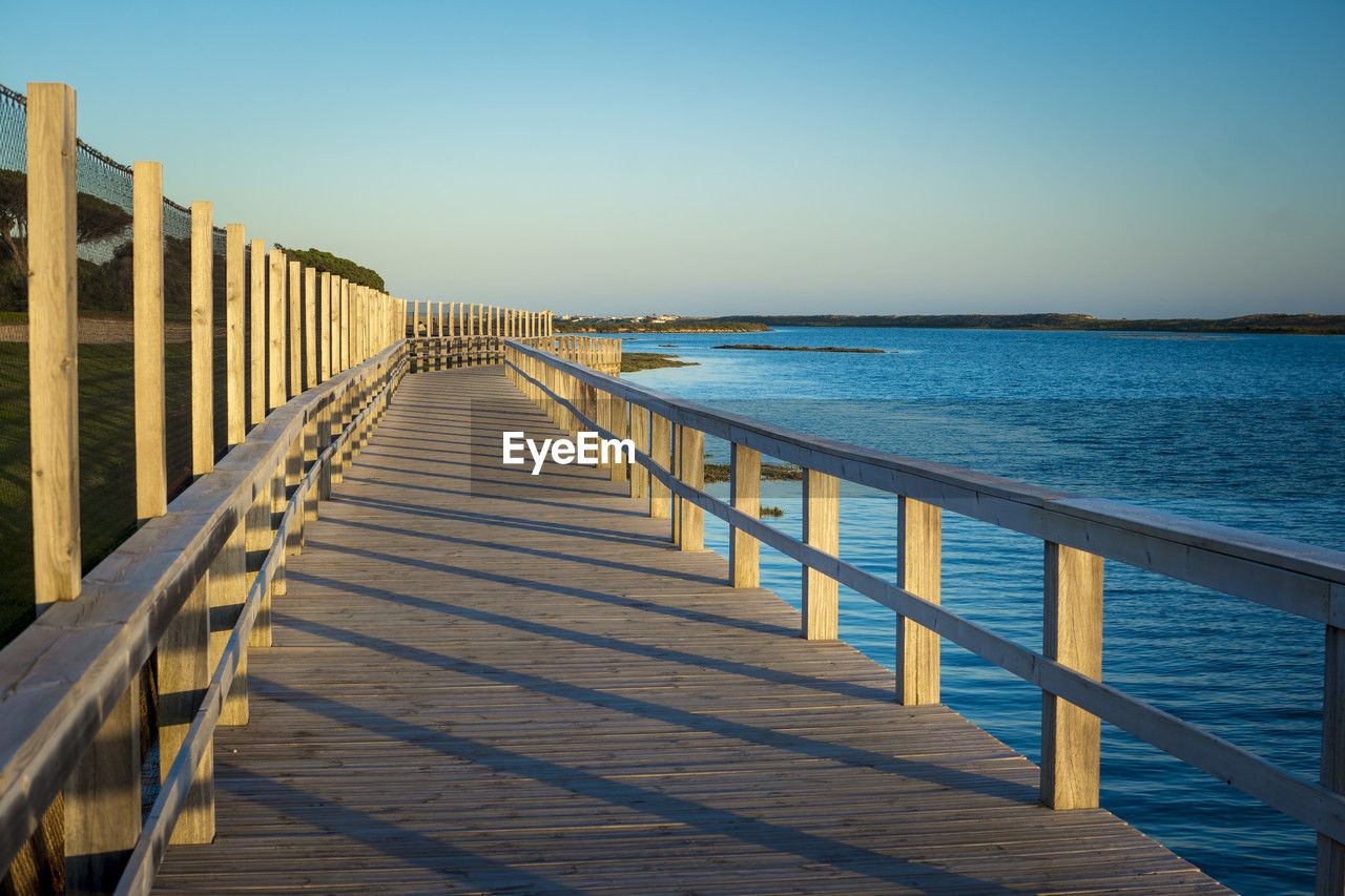 View on rio formosa wooden boardwalk near faro in the algarve, portugal