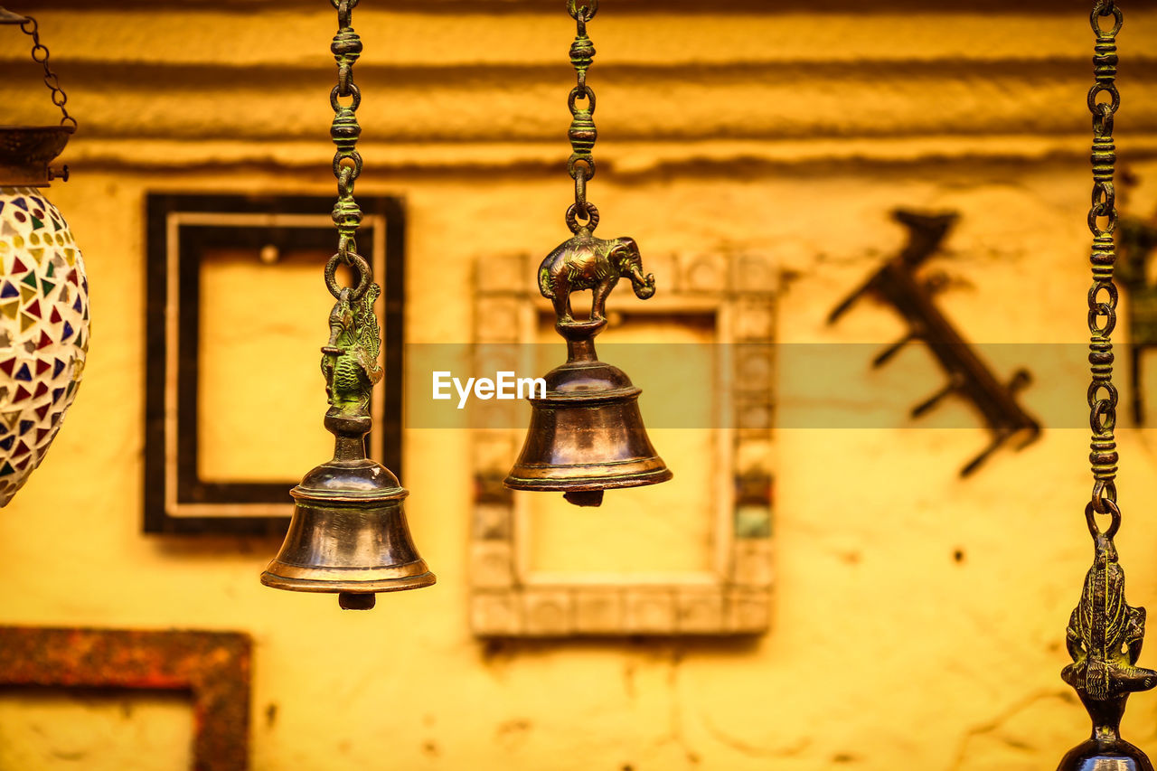 Close-up of bells hanging hanging outdoors