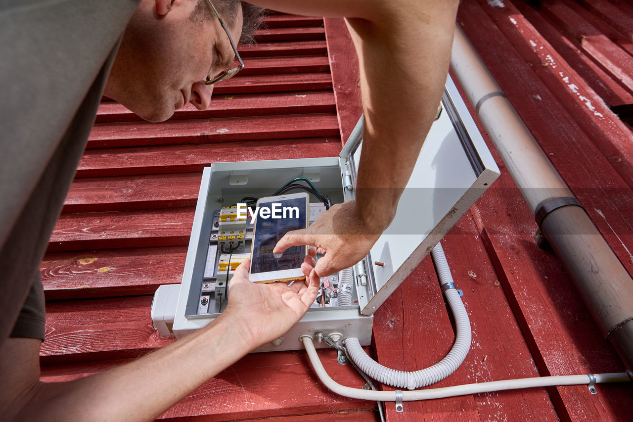 cropped hands of man repairing vehicle