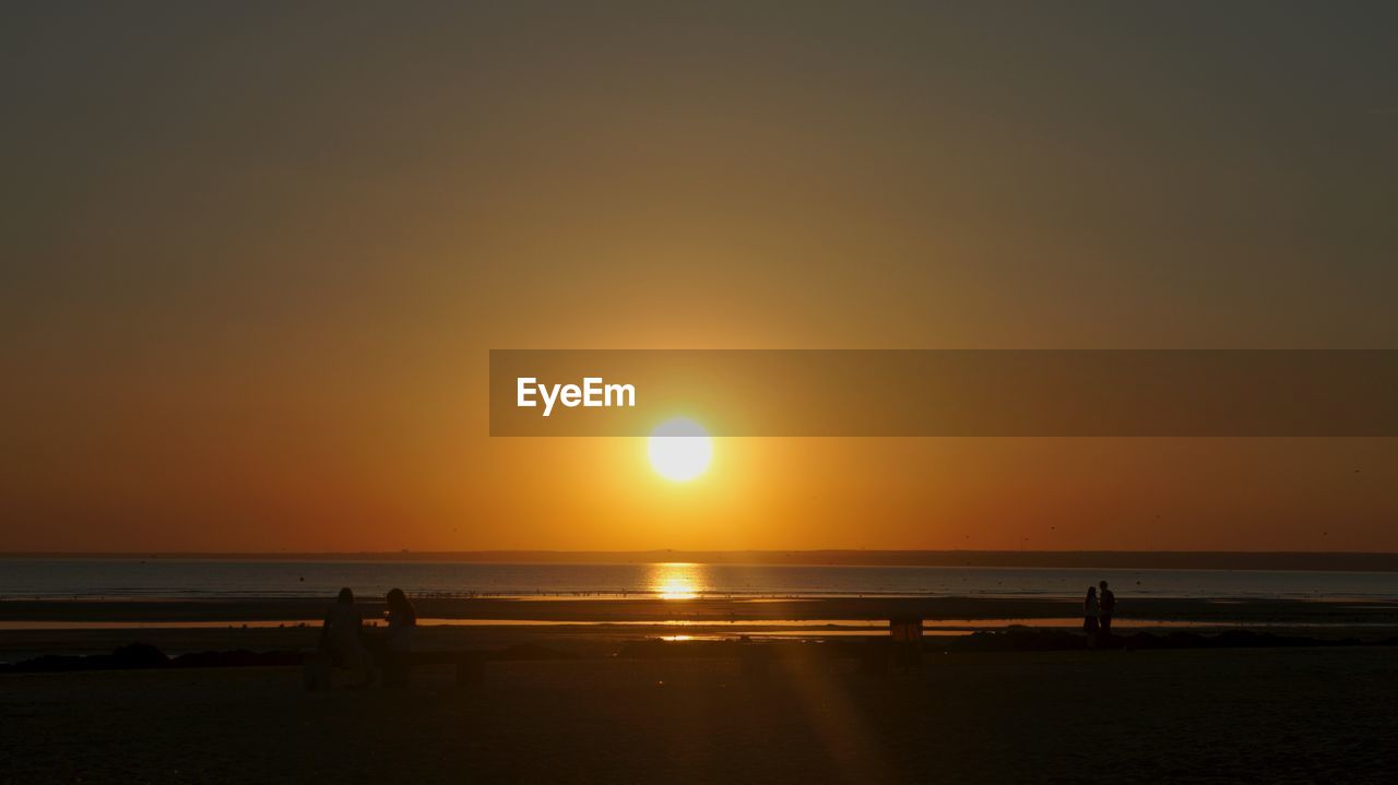 SCENIC VIEW OF BEACH DURING SUNSET