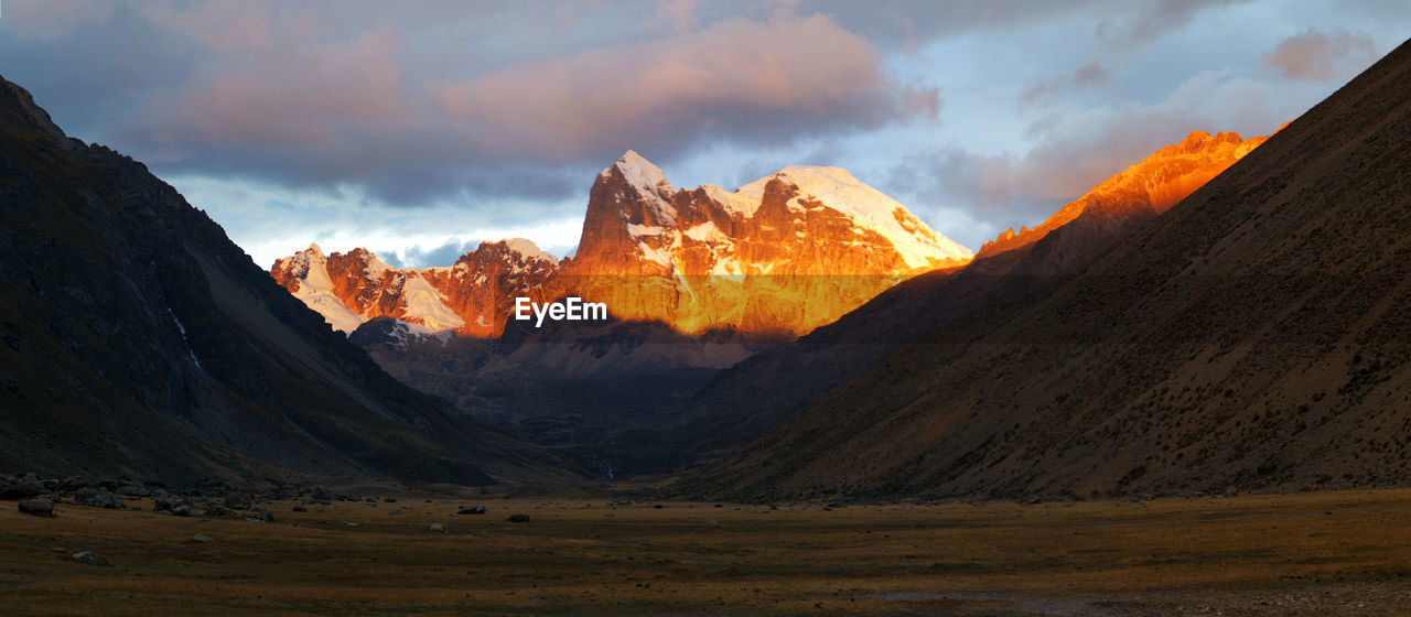 Panorama of spectacular sunset in the snowy mountains and valleyremote cordillera huayhuash in peru.