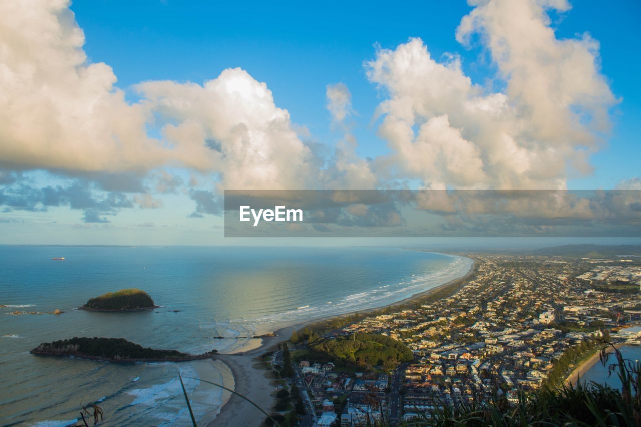 PANORAMIC SHOT OF SEA AND CITYSCAPE AGAINST SKY