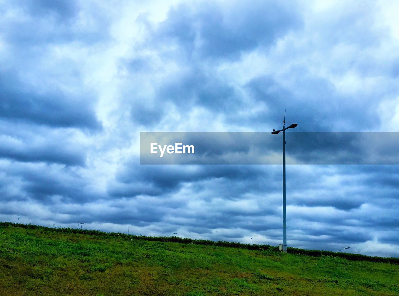 LOW ANGLE VIEW OF GREEN FIELD AGAINST SKY