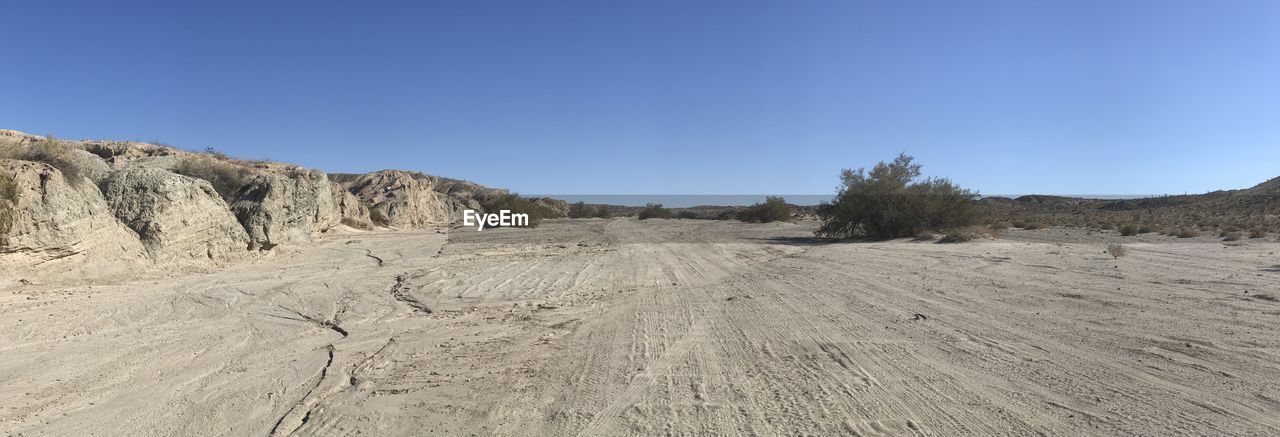 SCENIC VIEW OF DESERT AGAINST BLUE SKY