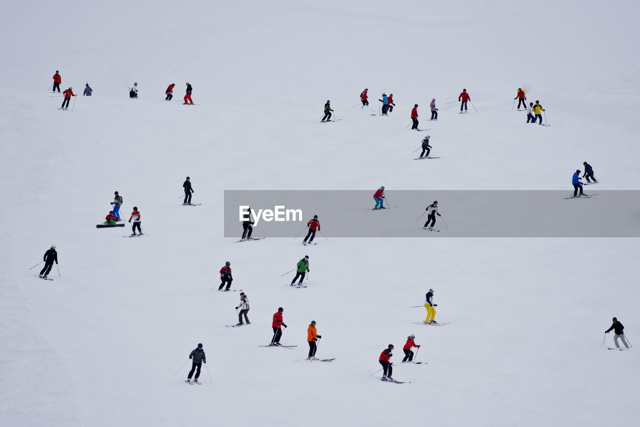 High angle view of people skiing on snow during winter