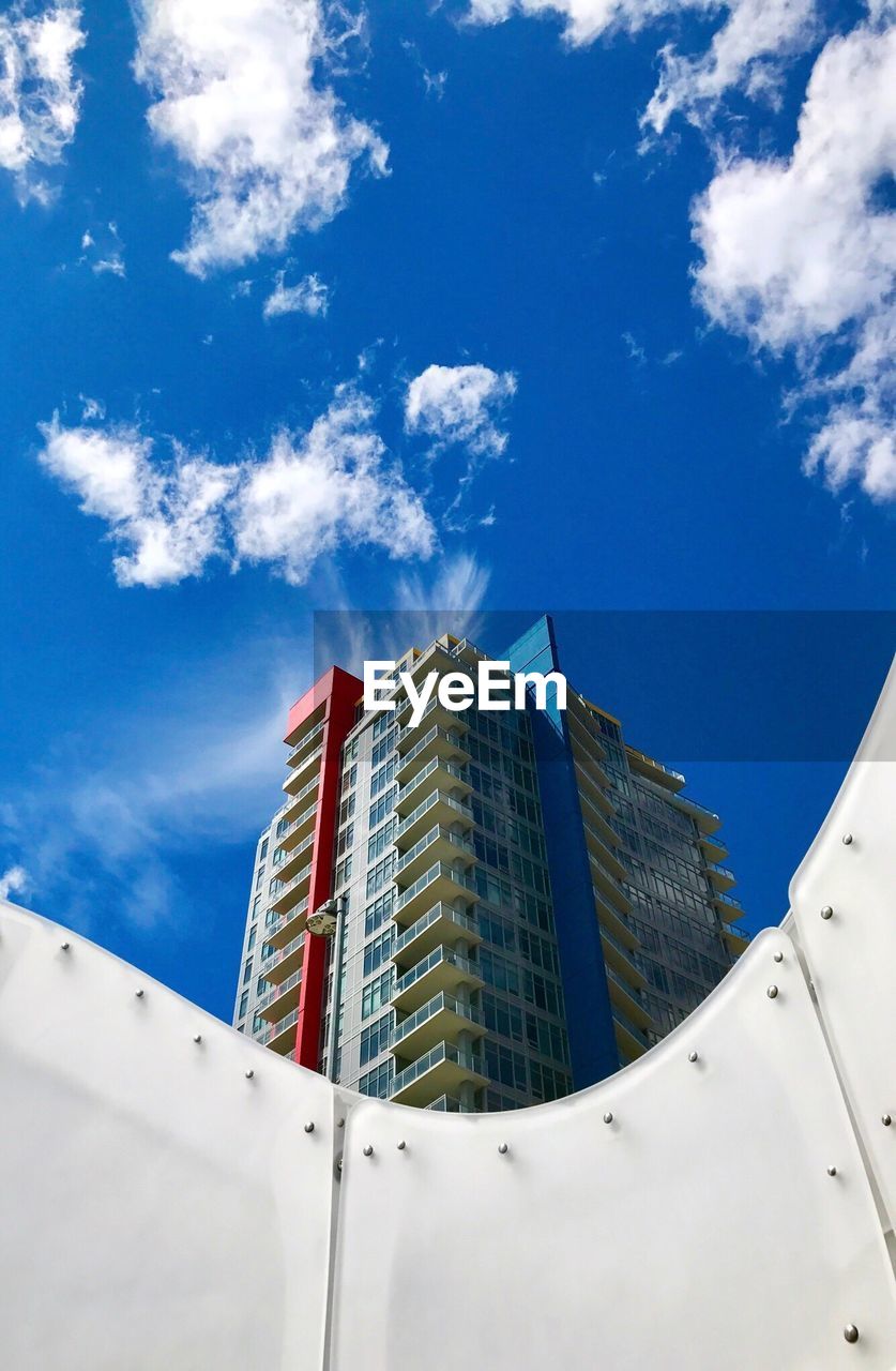 Low angle view of modern building against blue sky