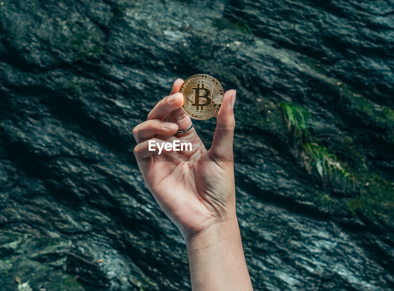 Close-up of hand holding bitcoin