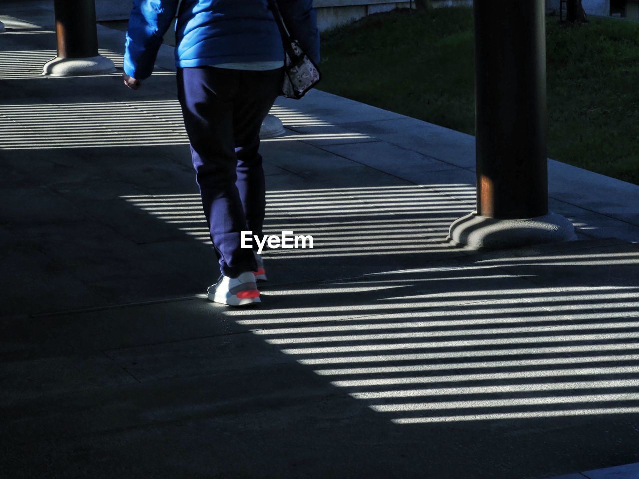 LOW SECTION OF MAN WALKING ON ZEBRA CROSSING