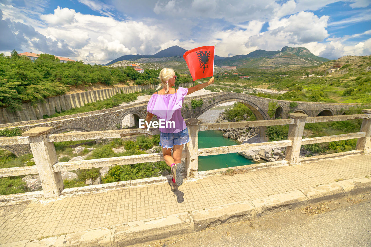 rear view of woman walking on road