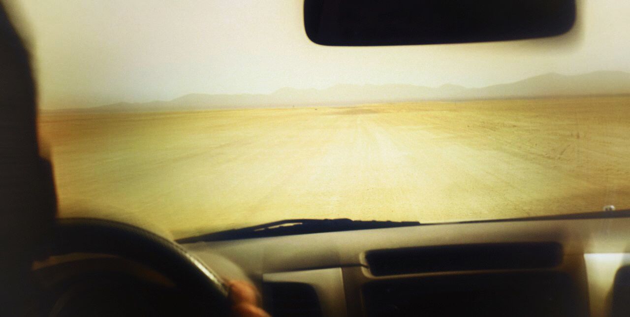 CROPPED IMAGE OF TRAIN ON ROAD