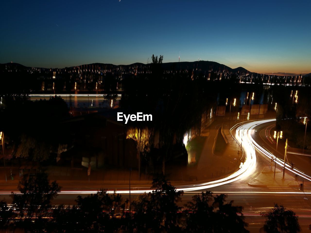 High angle view of light trails on road at night