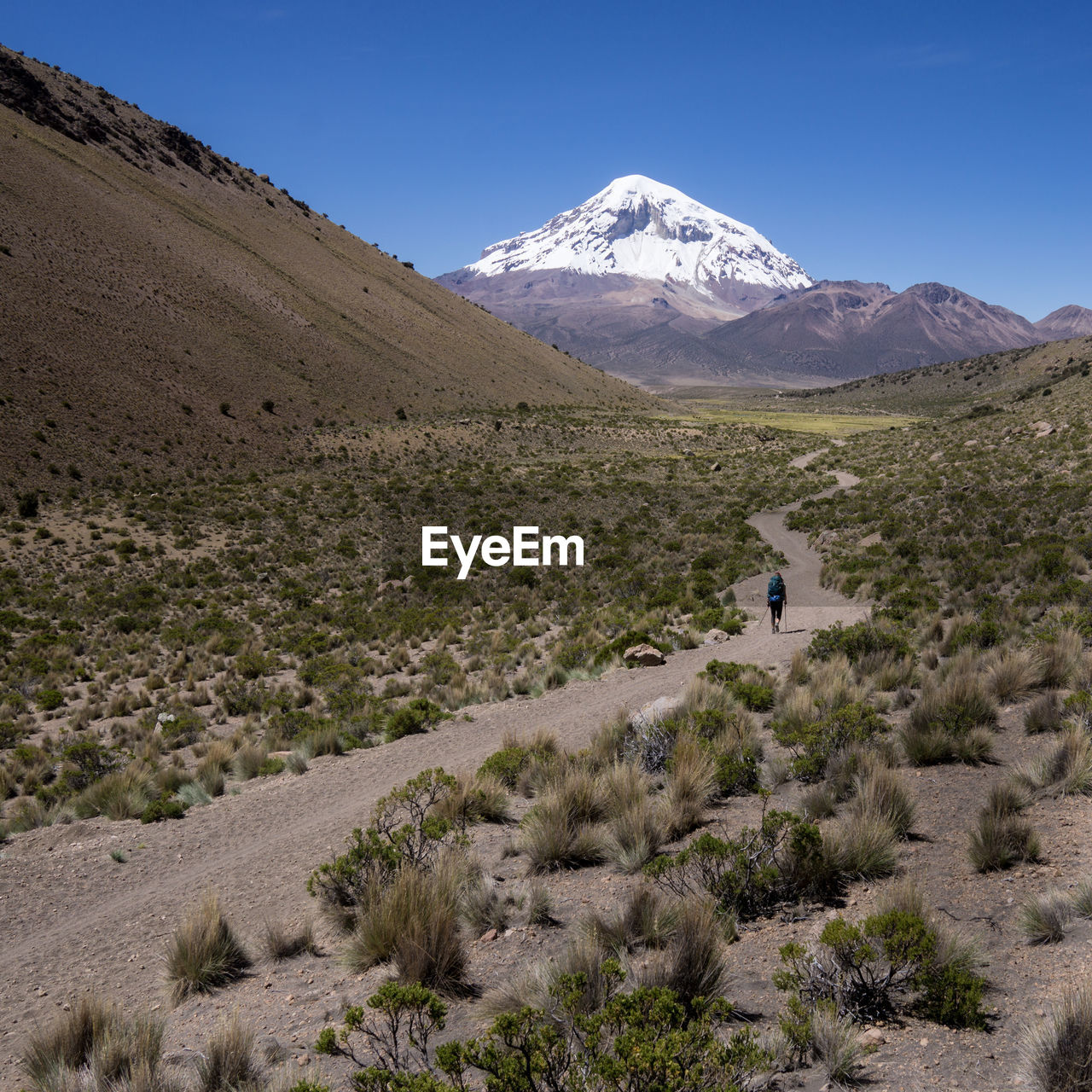 Scenic view of snowcapped mountains against blue sky