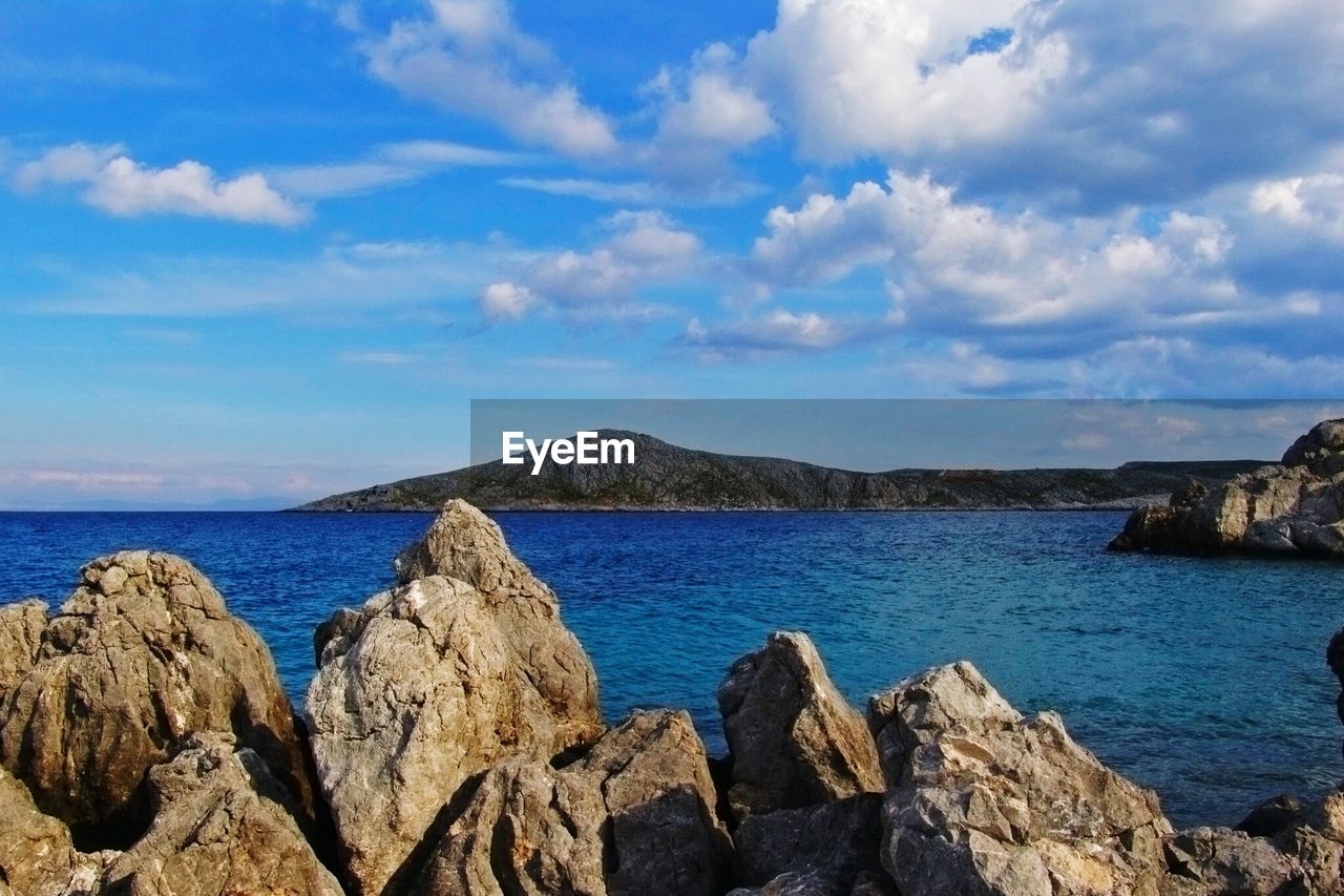 Lake against cloudy sky