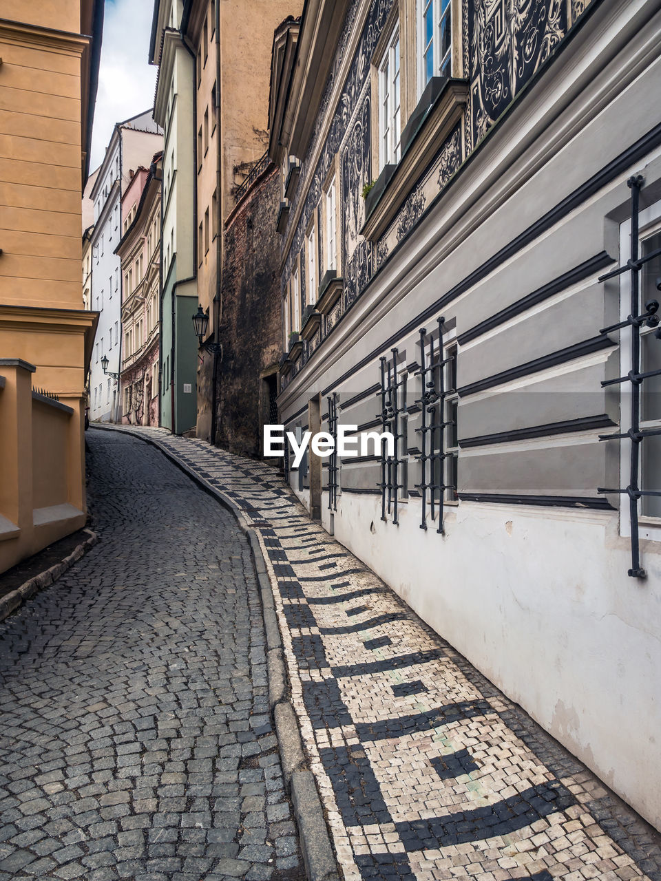 EMPTY ALLEY AMIDST BUILDINGS