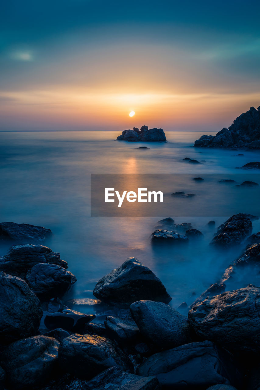 Scenic view of sea against sky during sunset