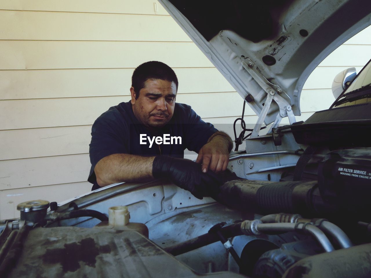 Mechanic repairing car engine