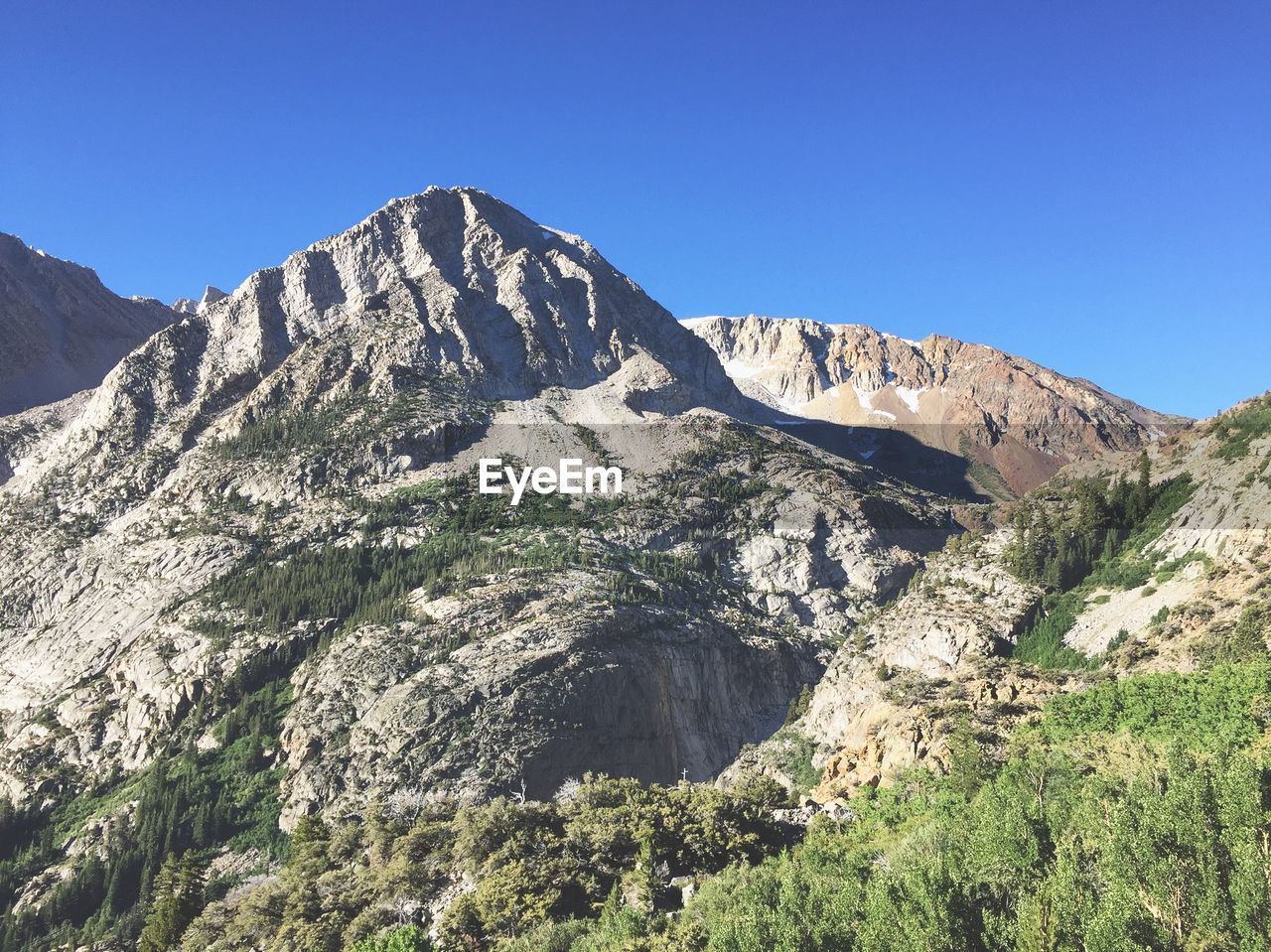 LOW ANGLE VIEW OF MOUNTAIN AGAINST BLUE SKY