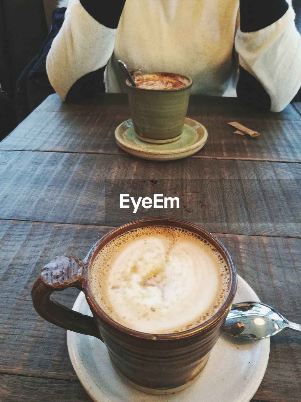 HIGH ANGLE VIEW OF COFFEE ON TABLE IN CAFE