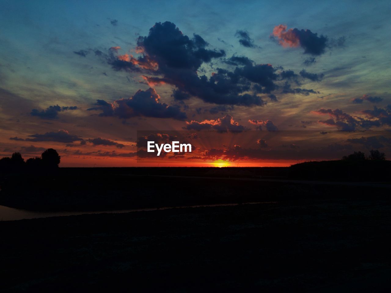 Scenic view of silhouette land against sky during sunset