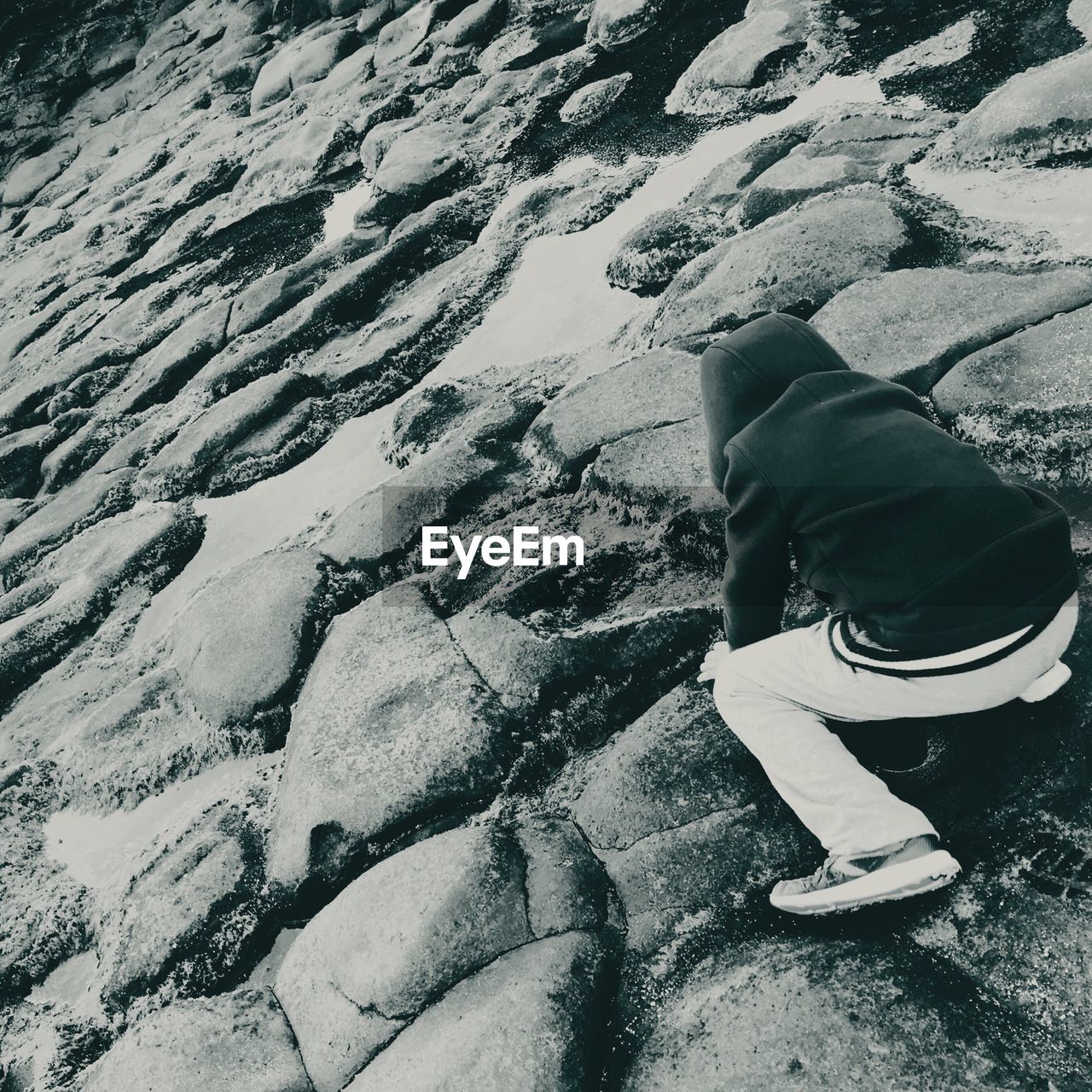 High angle view of boy playing on rocks