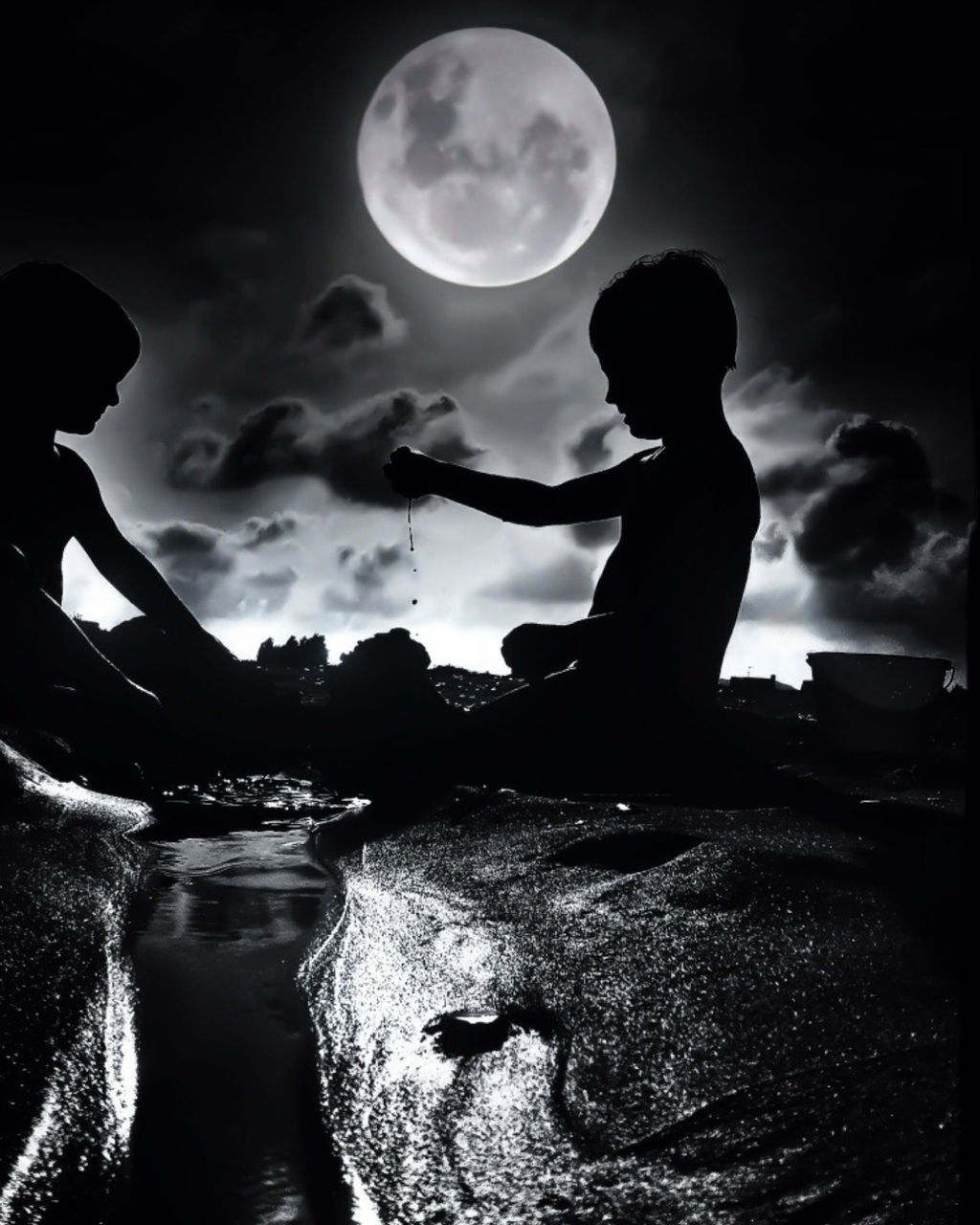 Friends playing on beach against sky at night