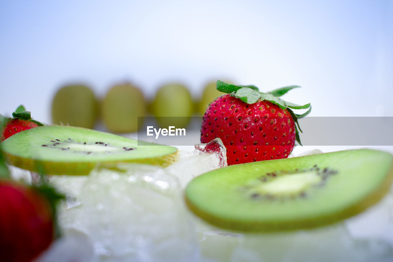 Close-up of strawberries with kiwi on ice