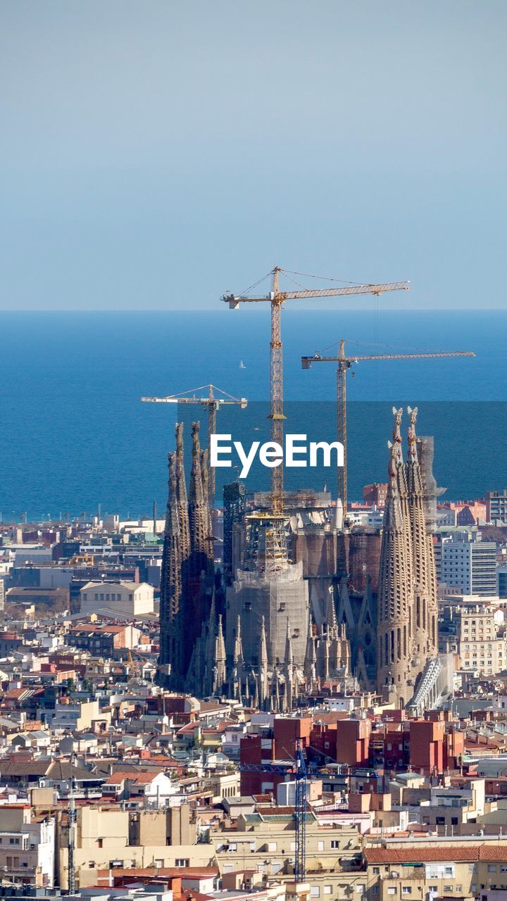 VIEW OF CITYSCAPE WITH SEA IN BACKGROUND