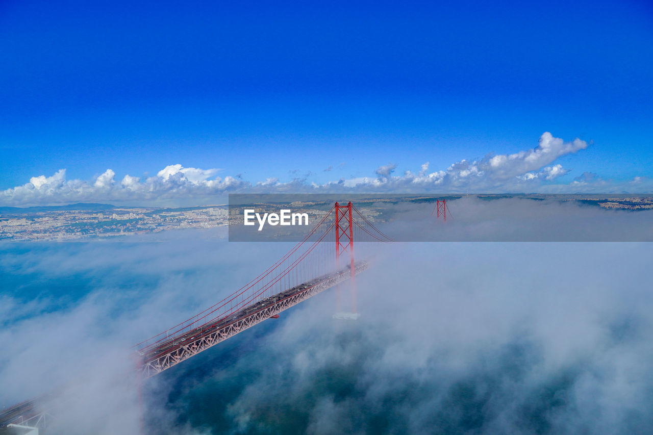 Aerial view of bridge over water against blue sky. 25th april bridge, lisbon, portugal 