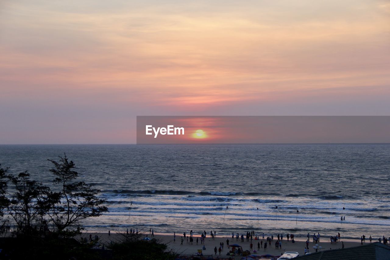 SCENIC VIEW OF SEA AGAINST ORANGE SKY