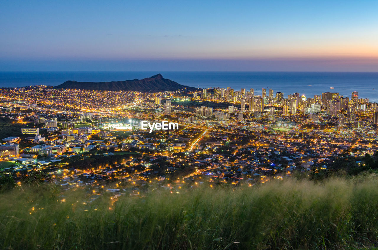 High angle view of illuminated buildings against sky in honolulu. hawaii on oahu. 