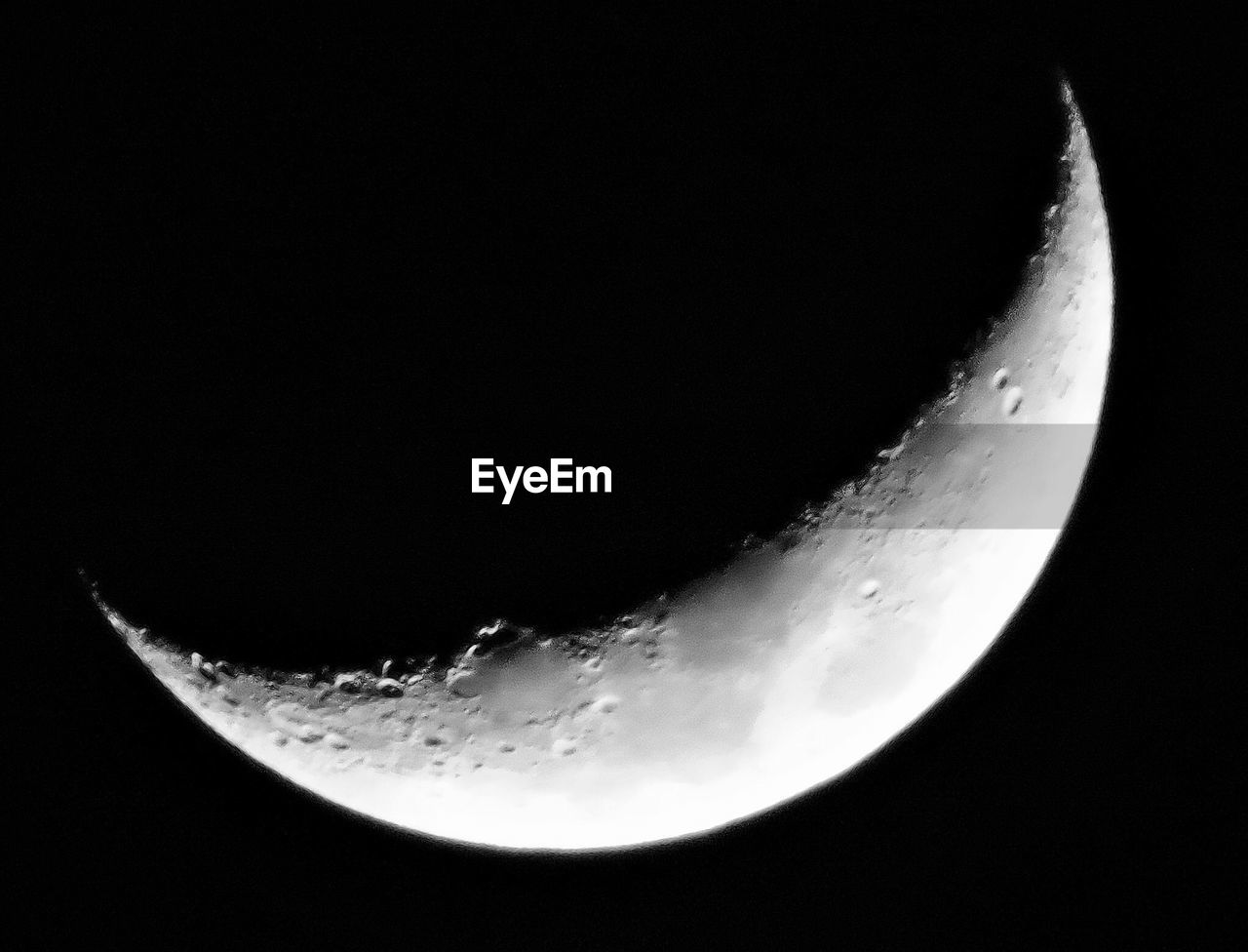 LOW ANGLE VIEW OF HALF MOON IN SKY