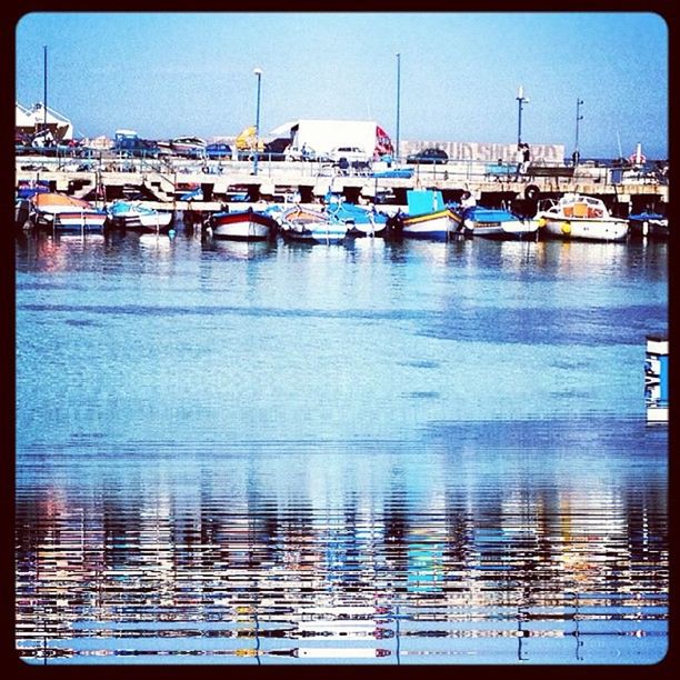 BOATS MOORED IN HARBOR