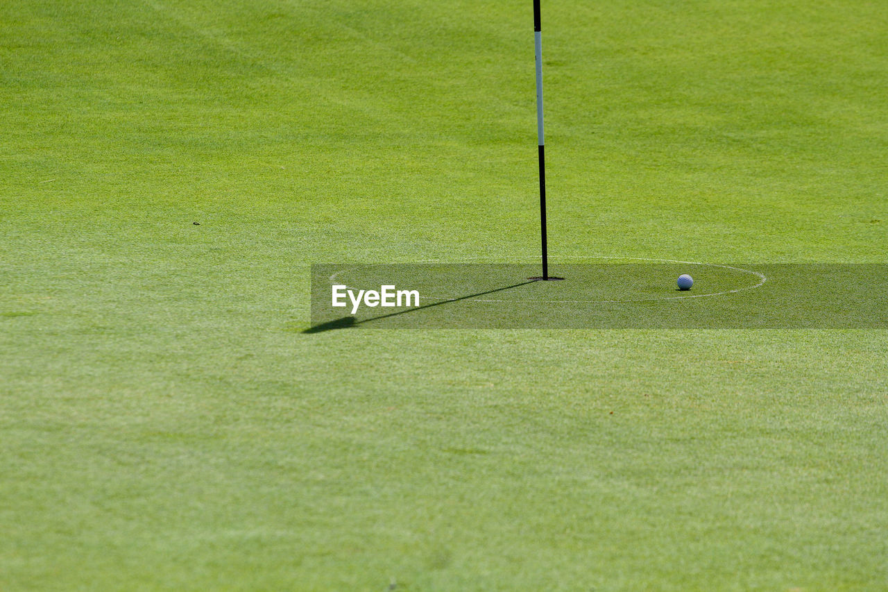 Ball on golf course in sunny day