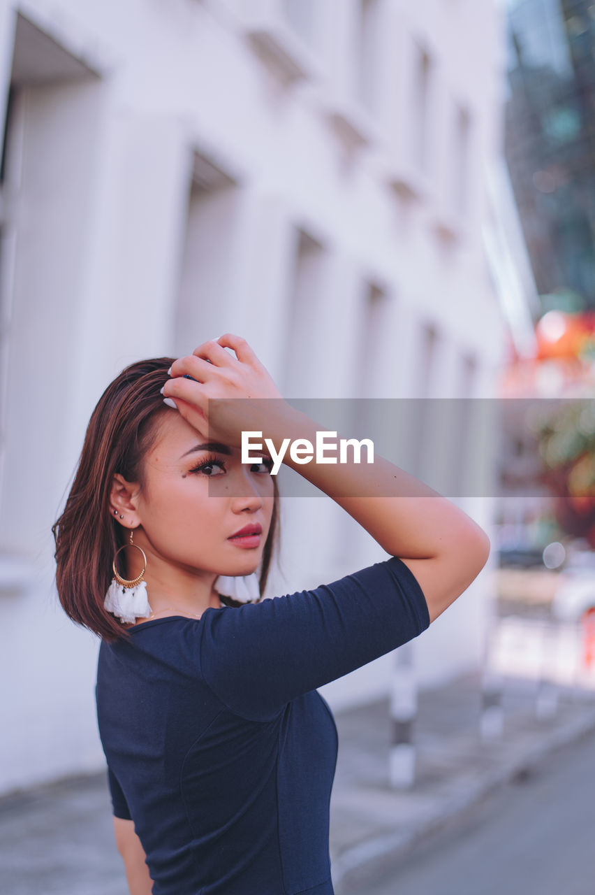 Portrait of beautiful young woman in city