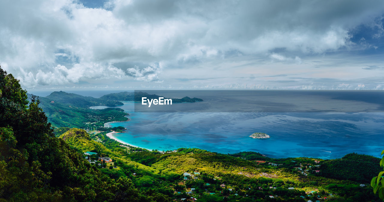 PANORAMIC VIEW OF SEA AND TREES AGAINST SKY